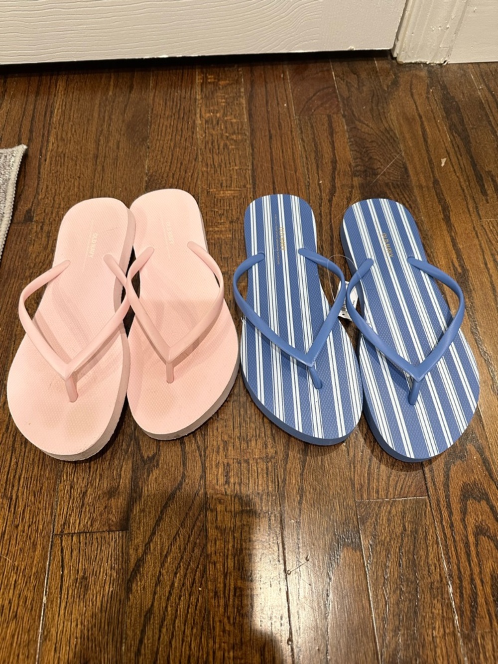 Pair of Pink Solid and Blue Striped Old Navy Flip Flops